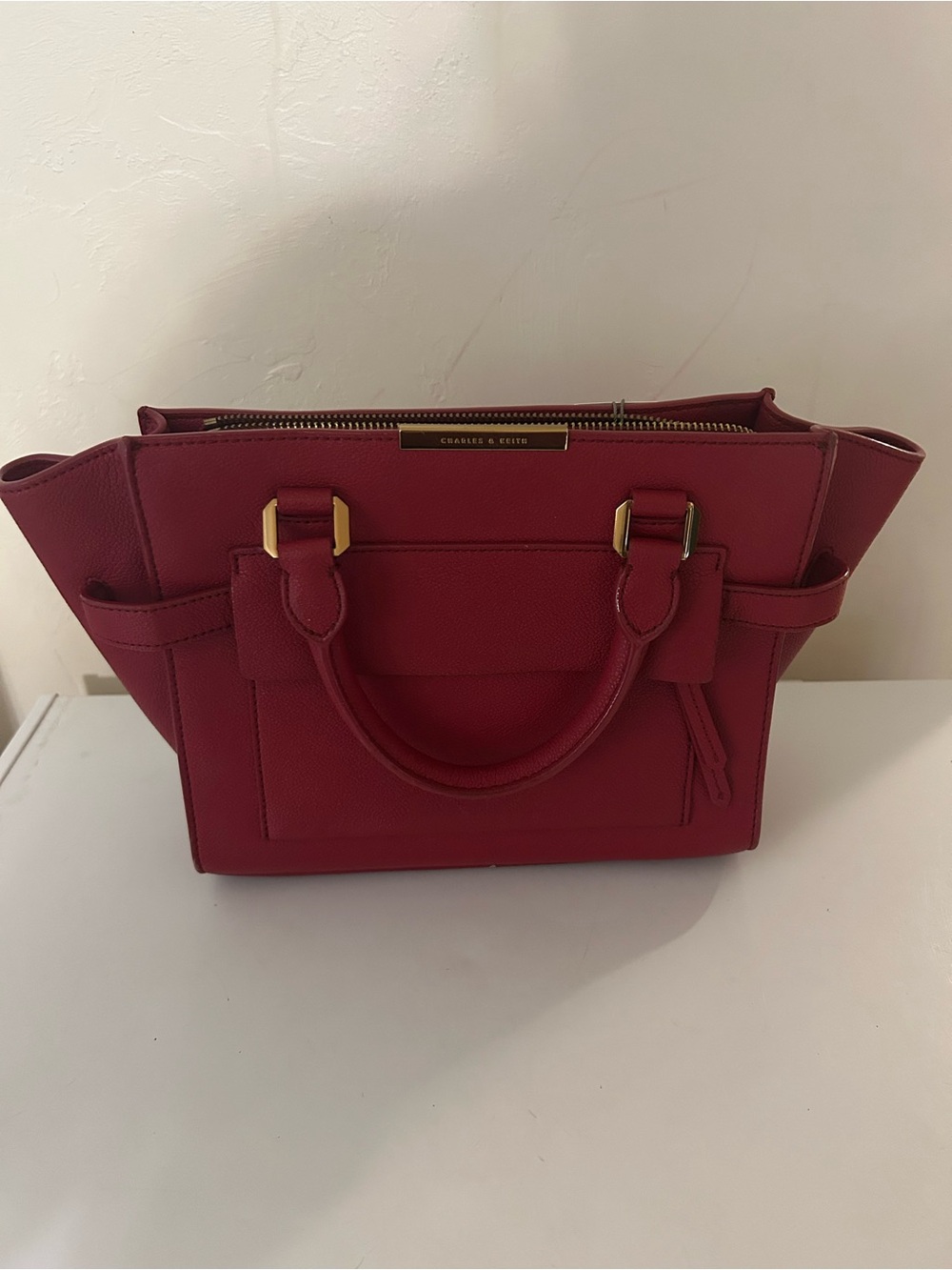 charles and Keith red handbag with gold accents